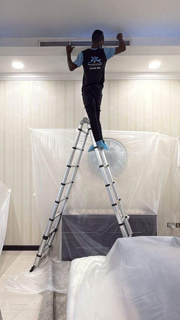 Fresh Air Cleaning certified technician performing AC duct cleaning in Dubai.
